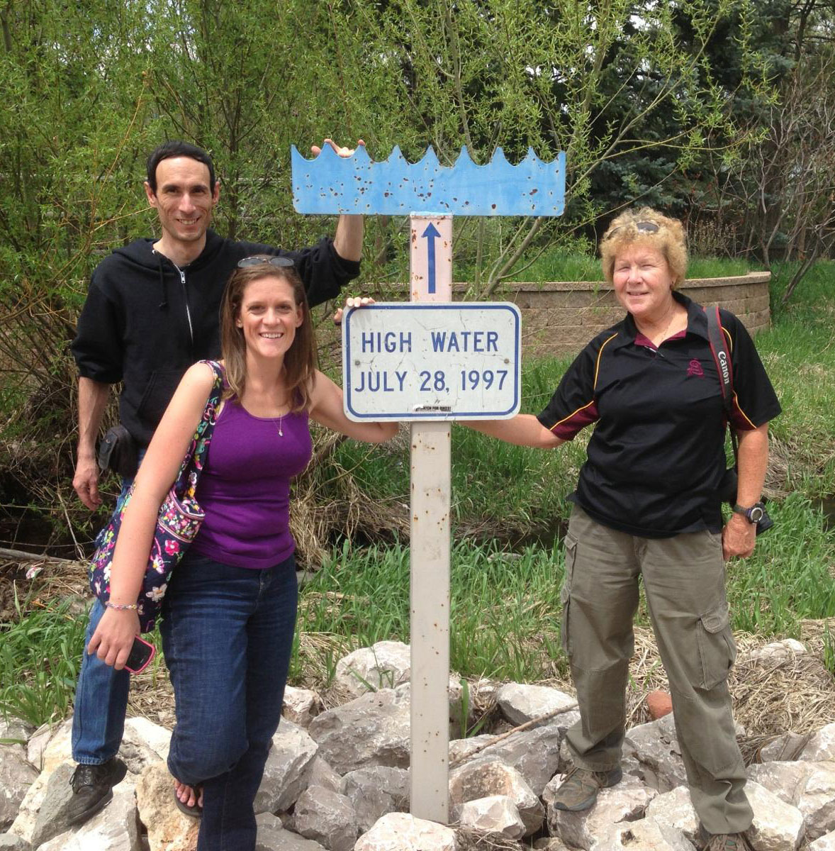 CoCoRaHS coordinators Tony (WY), Melissa (FL), and Nancy (AZ) at a high water mark for the 1997 Fort Collins, Colorado, flood.